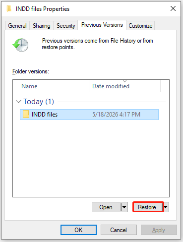 The Previous Versions tab of INDD files Properties with selected Restore.